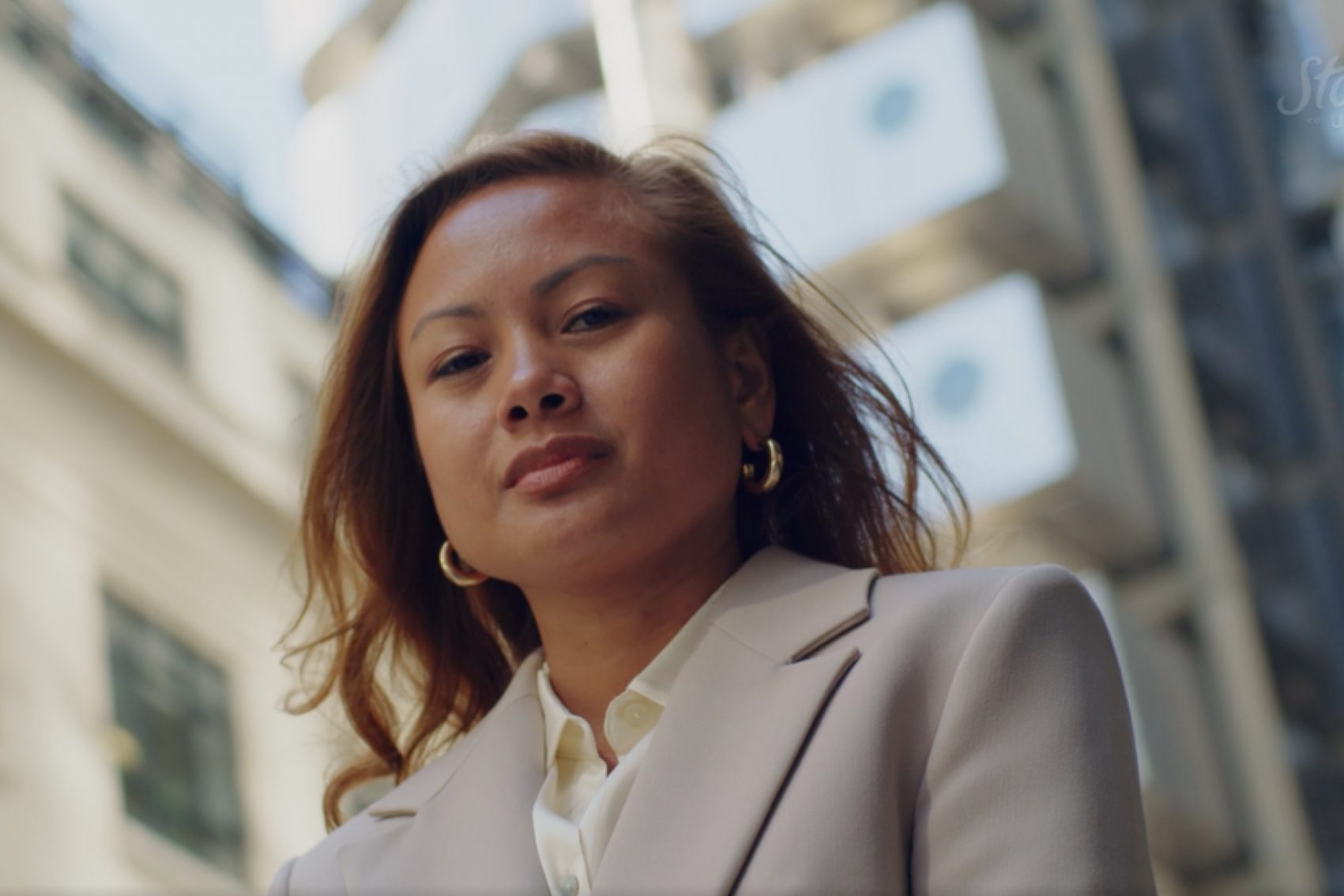 Business woman with an office building in the background - Strathsquare Point