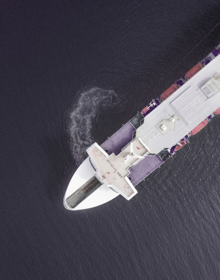 Aerial view of a container ship carrying cargo for an import-export logistics business in the ocean - Strathsquare Point